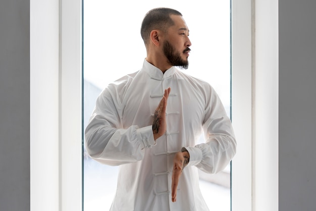 Person practicing tai chi indoors