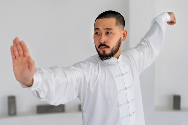 Person practicing tai chi indoors