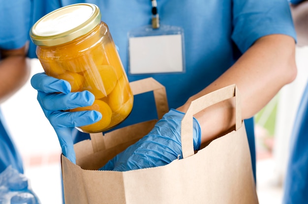 Free photo person preparing bag with provisions for food day