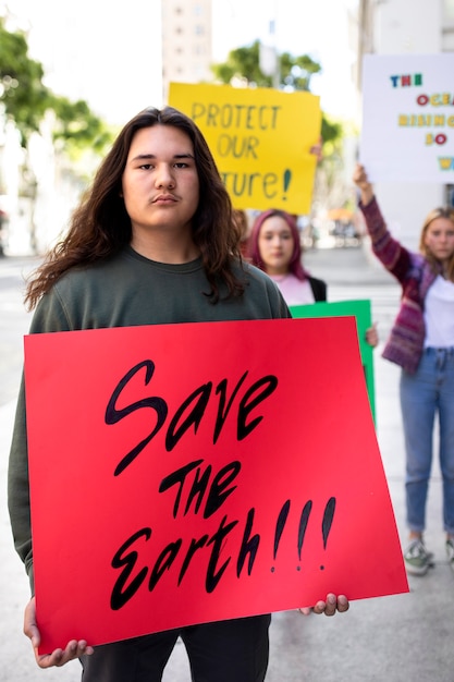 Free photo person protesting with placard for world environment day outdoors