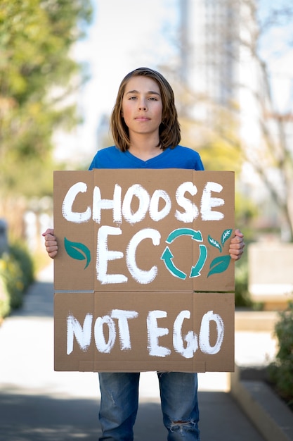 Person protesting with placard for world environment day outdoors