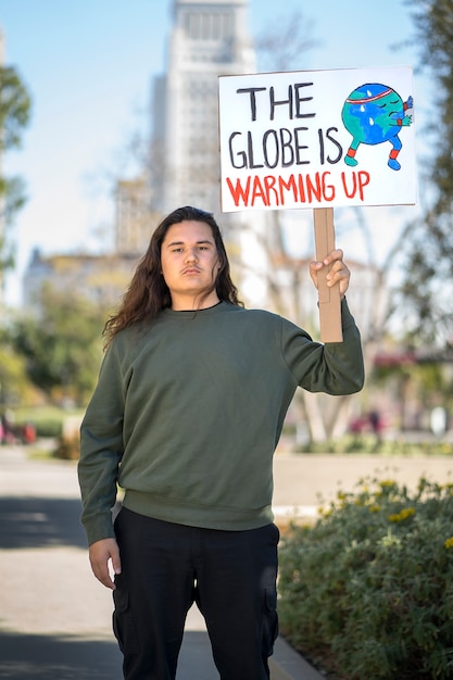 Free photo person protesting with placard for world environment day outdoors