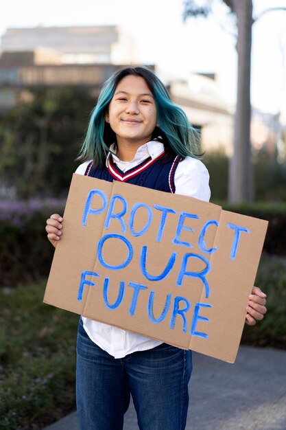 Person protesting with placard for world environment day outdoors