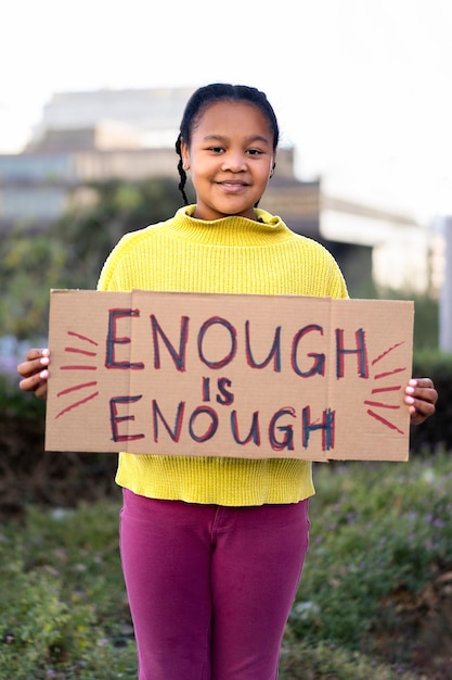 Person protesting with placard for world environment day outdoors