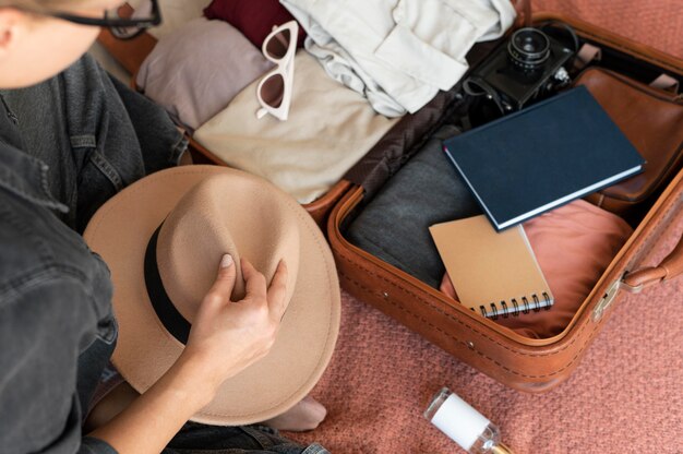 Person putting clothes in a suitcase for her vacation