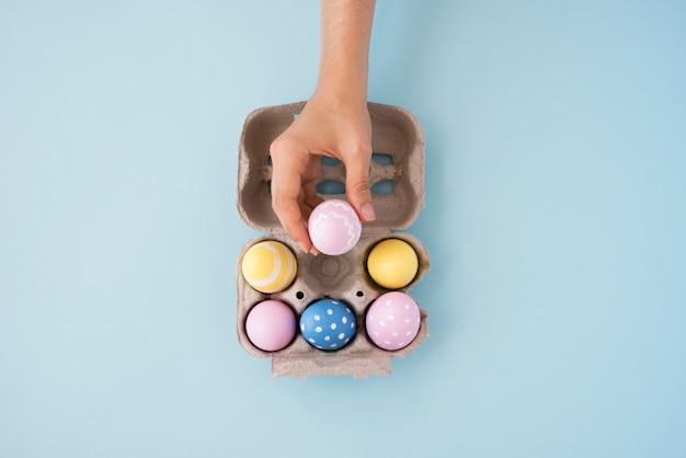 Person putting Easter egg in box 