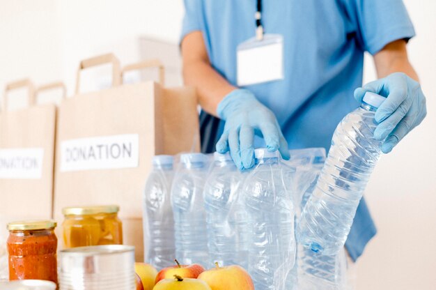 Person putting water bottles in donation bags