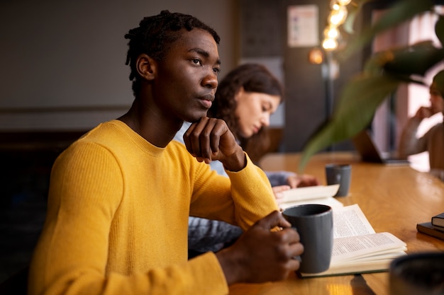 Person reading a book in a cafe