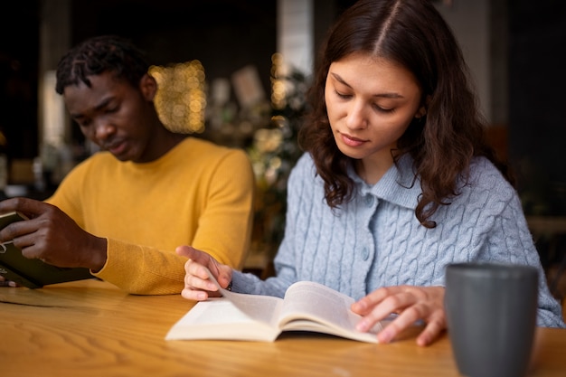 Person reading a book in a cafe