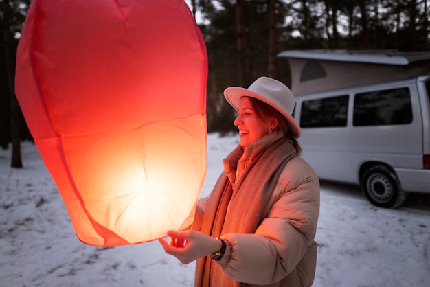 Free photo person releasing a flying lamp