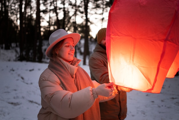 Free photo person releasing a flying lamp