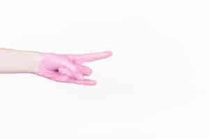 Free photo a person's hand with pink paint making horn sign