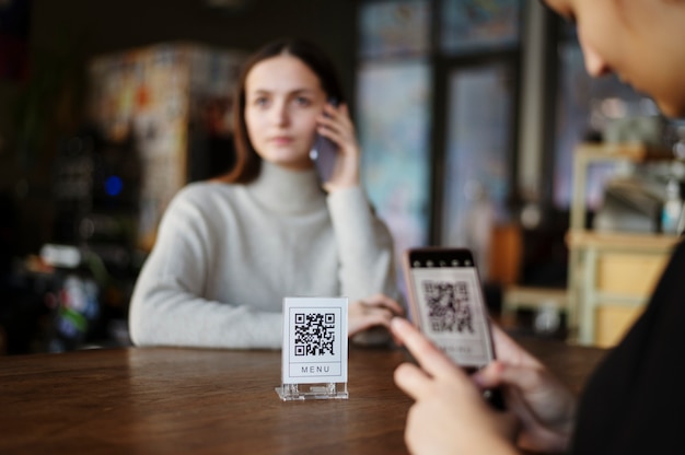 Free Photo person scanning qr code at the cafeteria