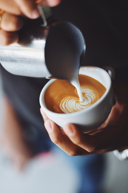 Person serving a cup of coffee