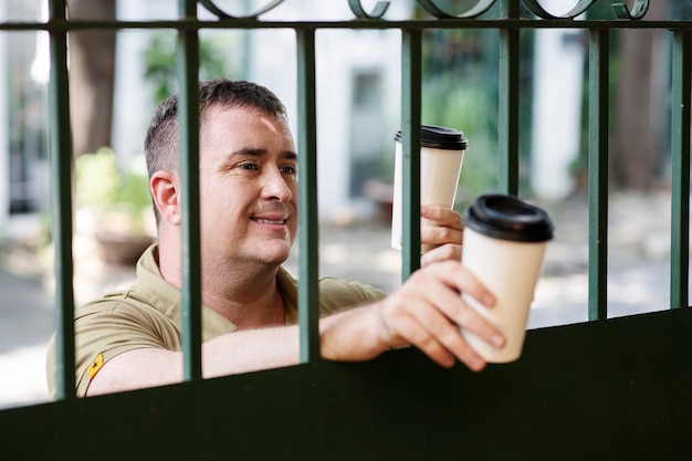 Free photo person sharing coffee with neighbor