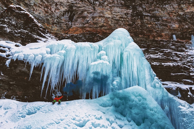 Free photo person sits on mountain with icicles