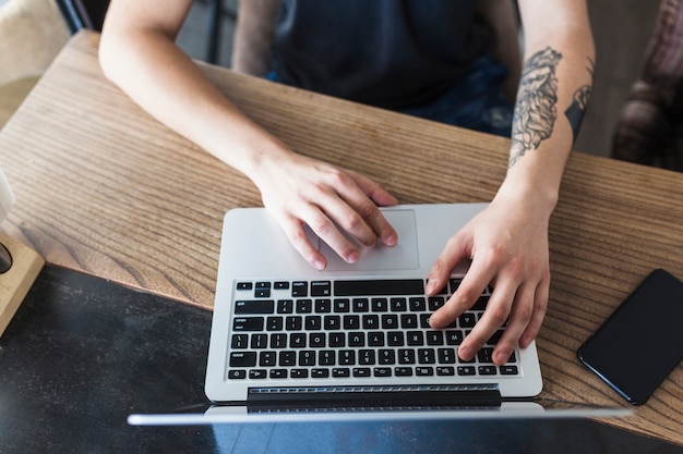 Person sitting at table with laptop 