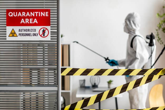 Person in special equipment disinfecting a restricted area