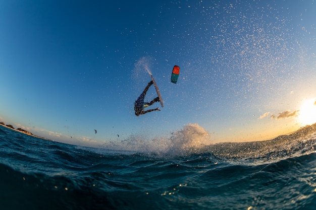 Person surfing and flying a parachute at the same time in Kitesurfing. Bonaire, Caribbean