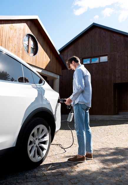 Free photo person taking care of electric car