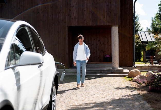 Free photo person taking care of electric car