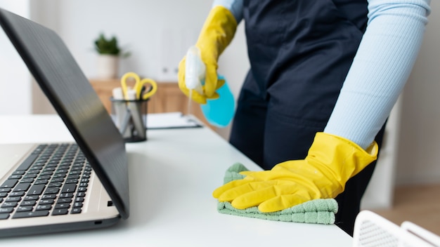 Free photo person taking care of office cleaning