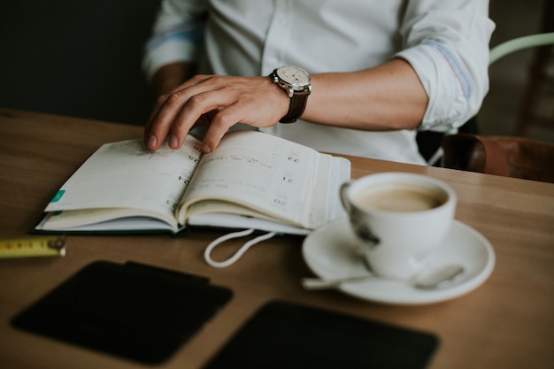 Free Photo person taking notes in a notebook while working from home