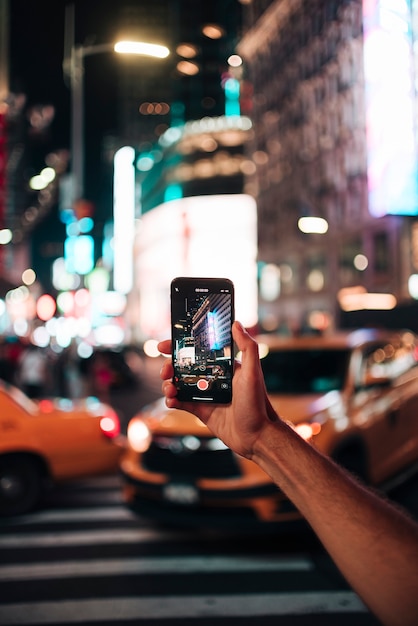 Person taking a picture with vivid city