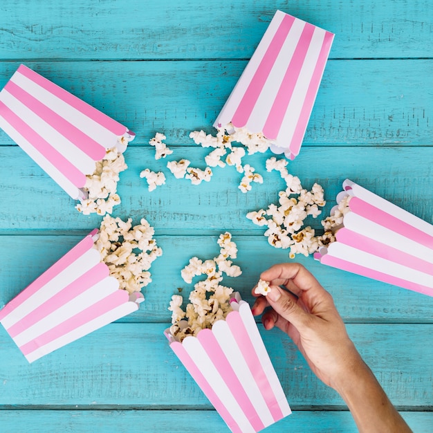 Free photo person taking popcorn from center of circle