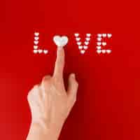 Free photo person touching heart in love inscription