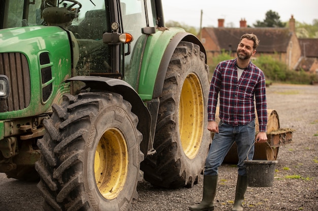 Free Photo person next to tractor