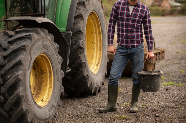 Free photo person next to tractor