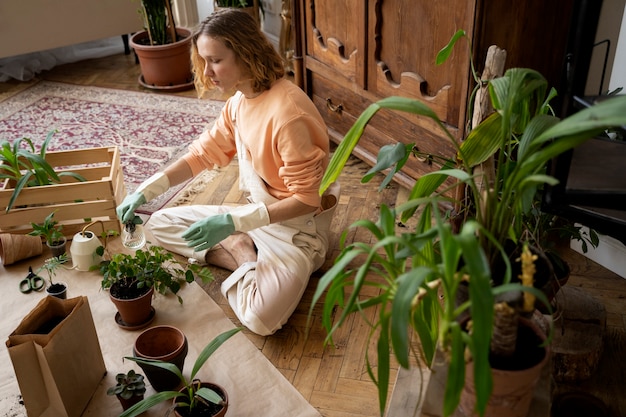 Person transplanting plants in new pots