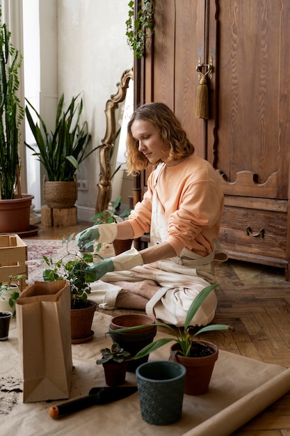 Person transplanting plants in new pots