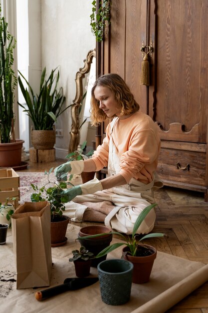 Person transplanting plants in new pots