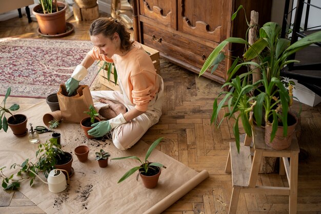 Person transplanting plants in new pots