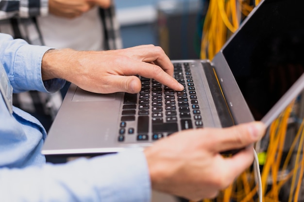 Free photo person typing on a laptop close-up