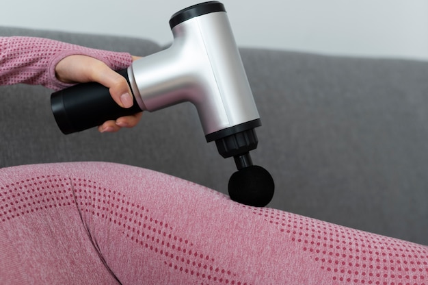 Free photo person using massage gun