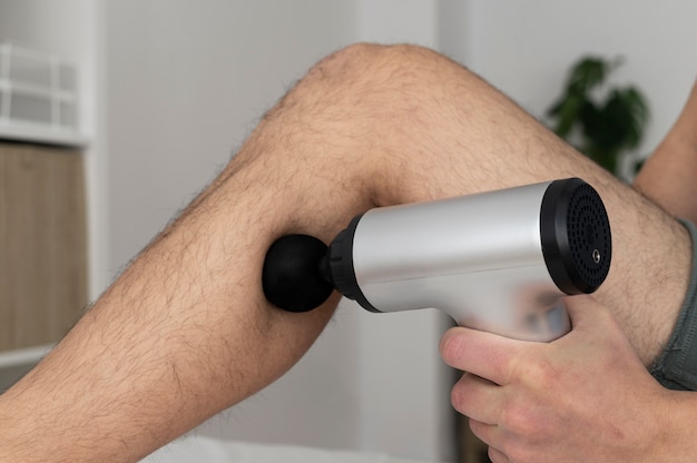 Free Photo person using massage gun