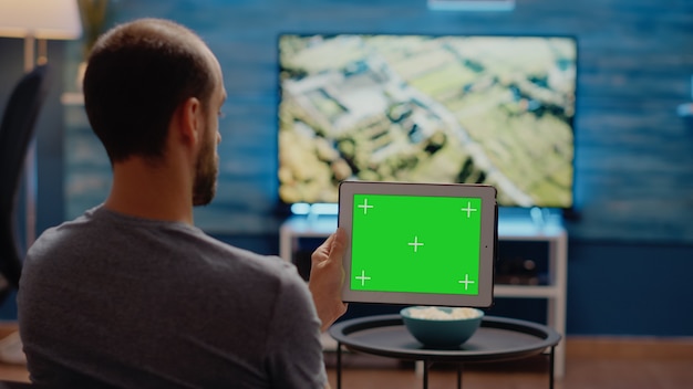 Person using modern tablet horizontally for green screen