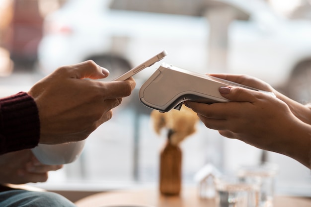 Free Photo person using nfc technology to pay the bill at a restaurant