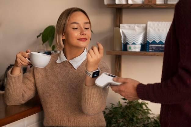 Person using nfc technology to pay the bill at a restaurant