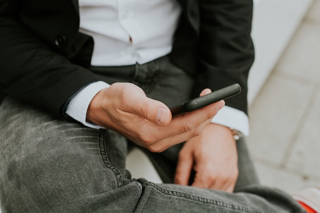 Person using a smartphone to check social media while sitting on the couch