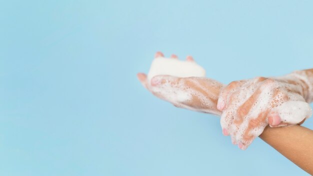 Person washing hands with soap