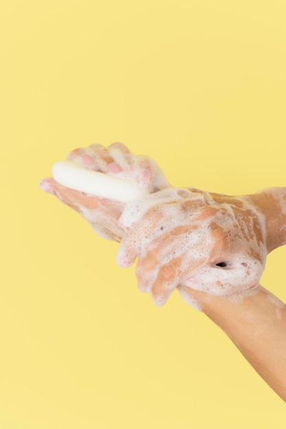 Person washing hands with soap