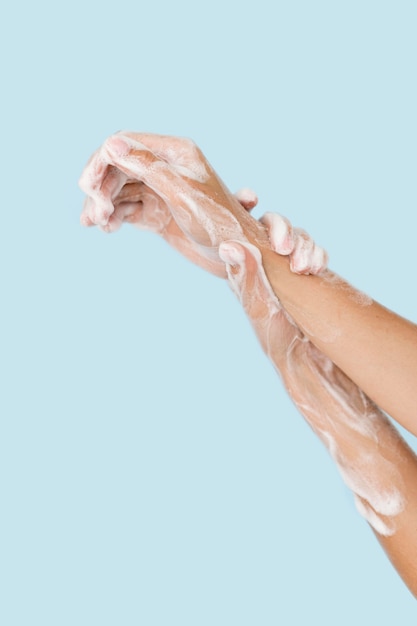 Person washing hands with soap