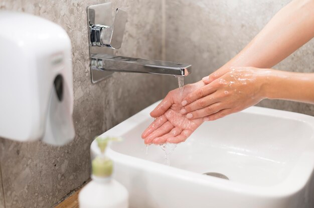 Person washing hands with soap