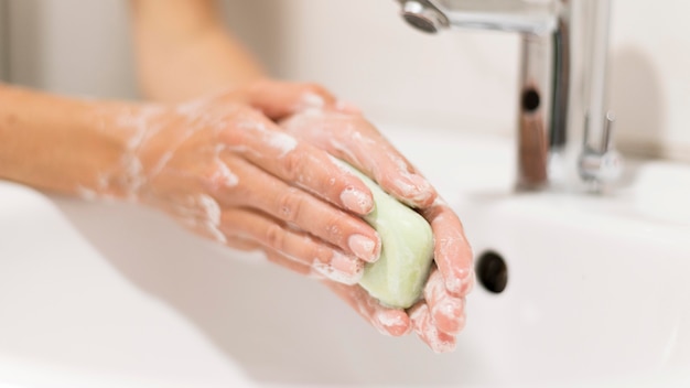 Person washing hands with soap