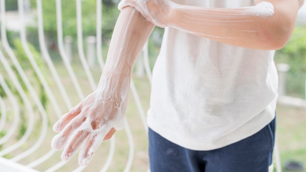 Free photo person washing hands with soap