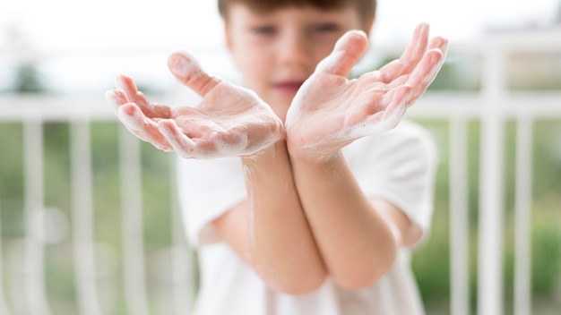 Person washing hands with soap